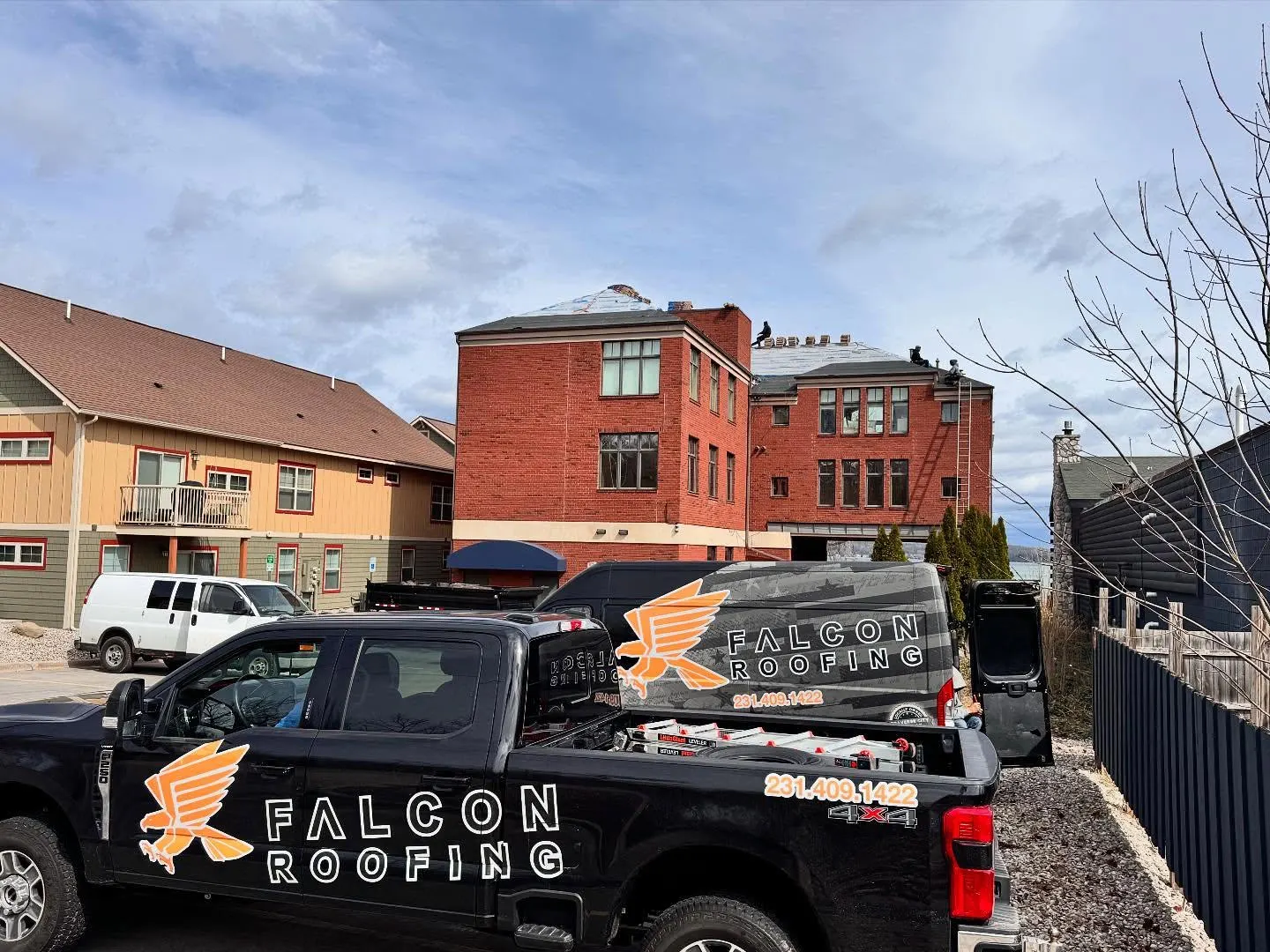 Falcon Roofing trucks, a locally owned Traverse City company, staged for a job.