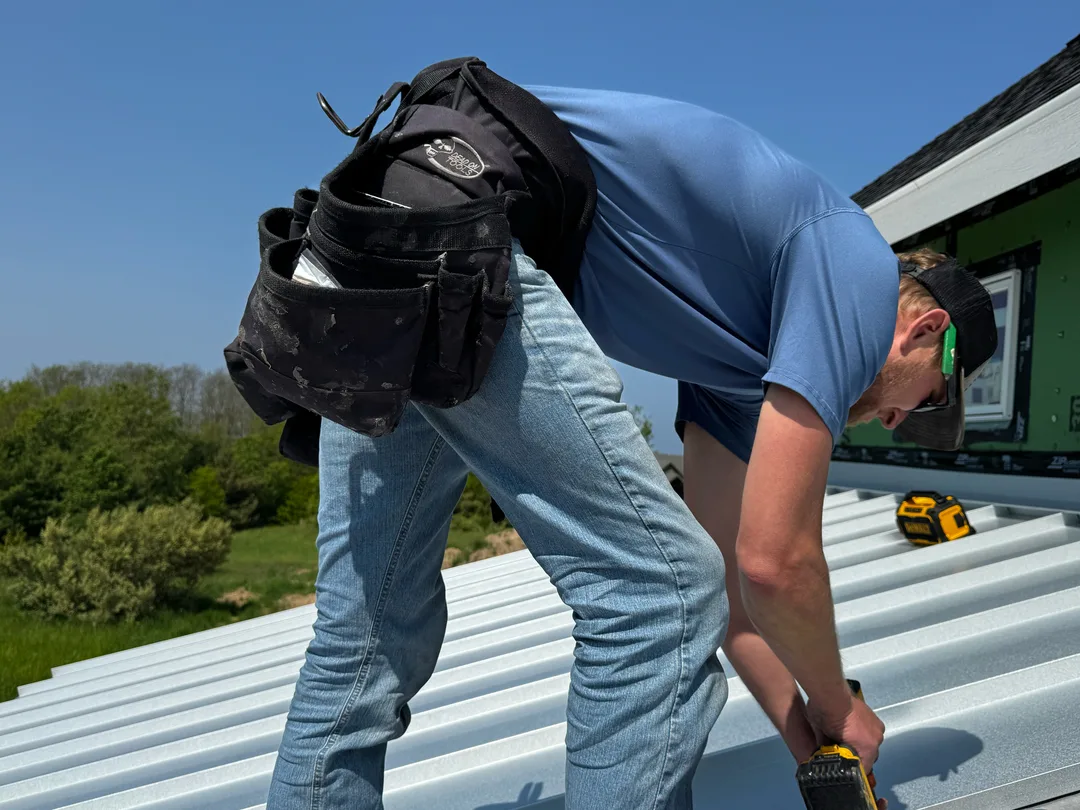 Installing corrugated metal panels on a Northern Michigan build.