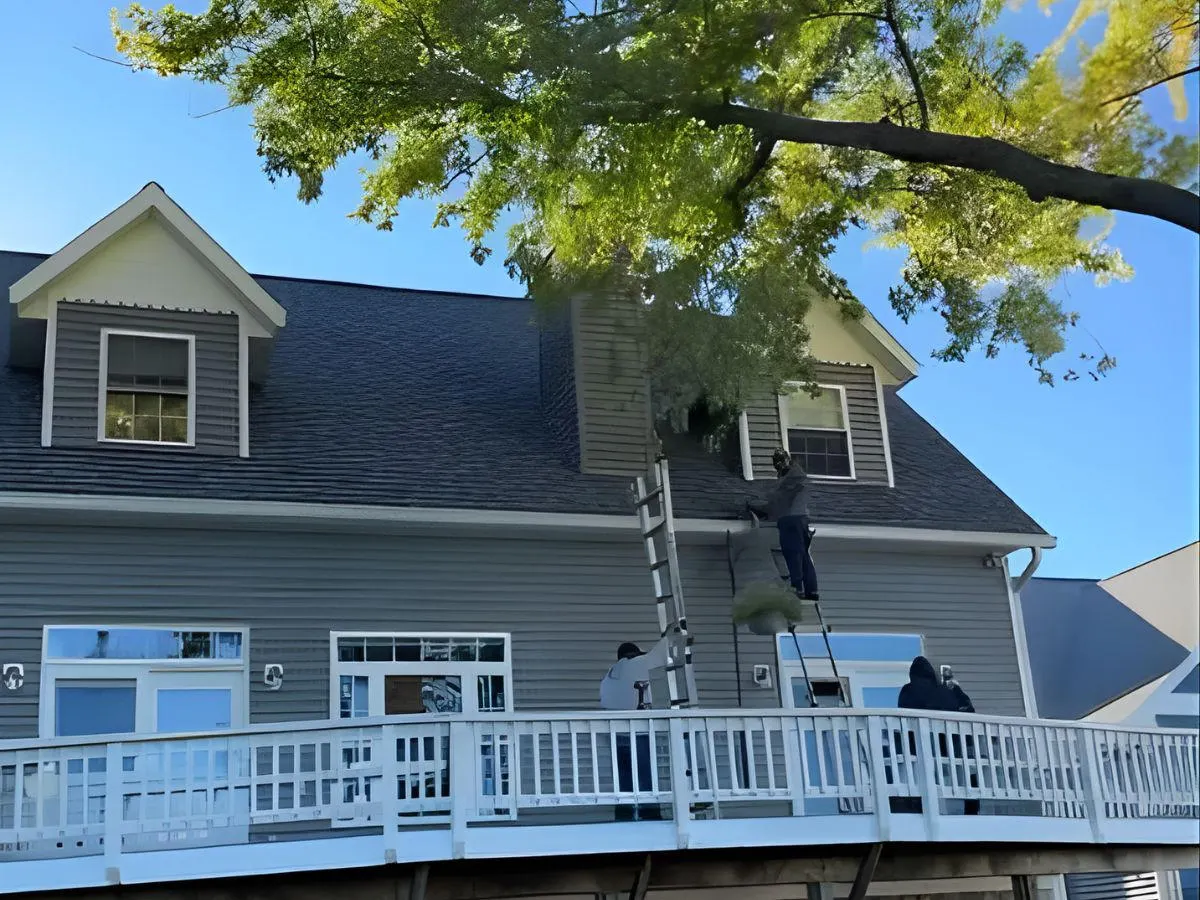 A Falcon Roofing crew accessing a Northern Michigan roof to inspect and document damage for an insurance claim.
