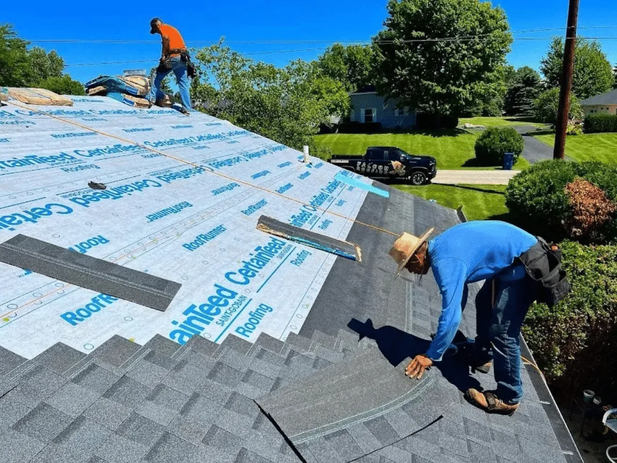 Falcon Roofing crew installing shingles on a Northern Michigan home